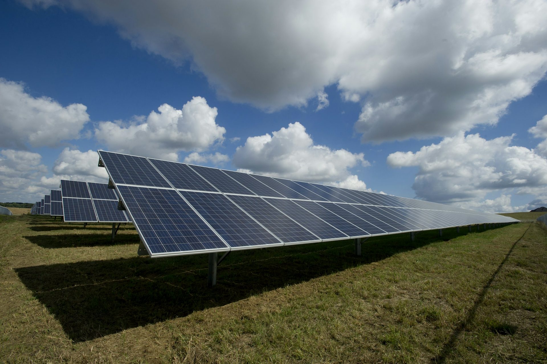 Solar panel array under a bright sky